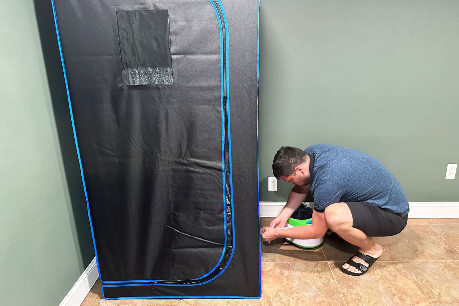 A person setting up the SereneLife Full Size Portable Steam Sauna