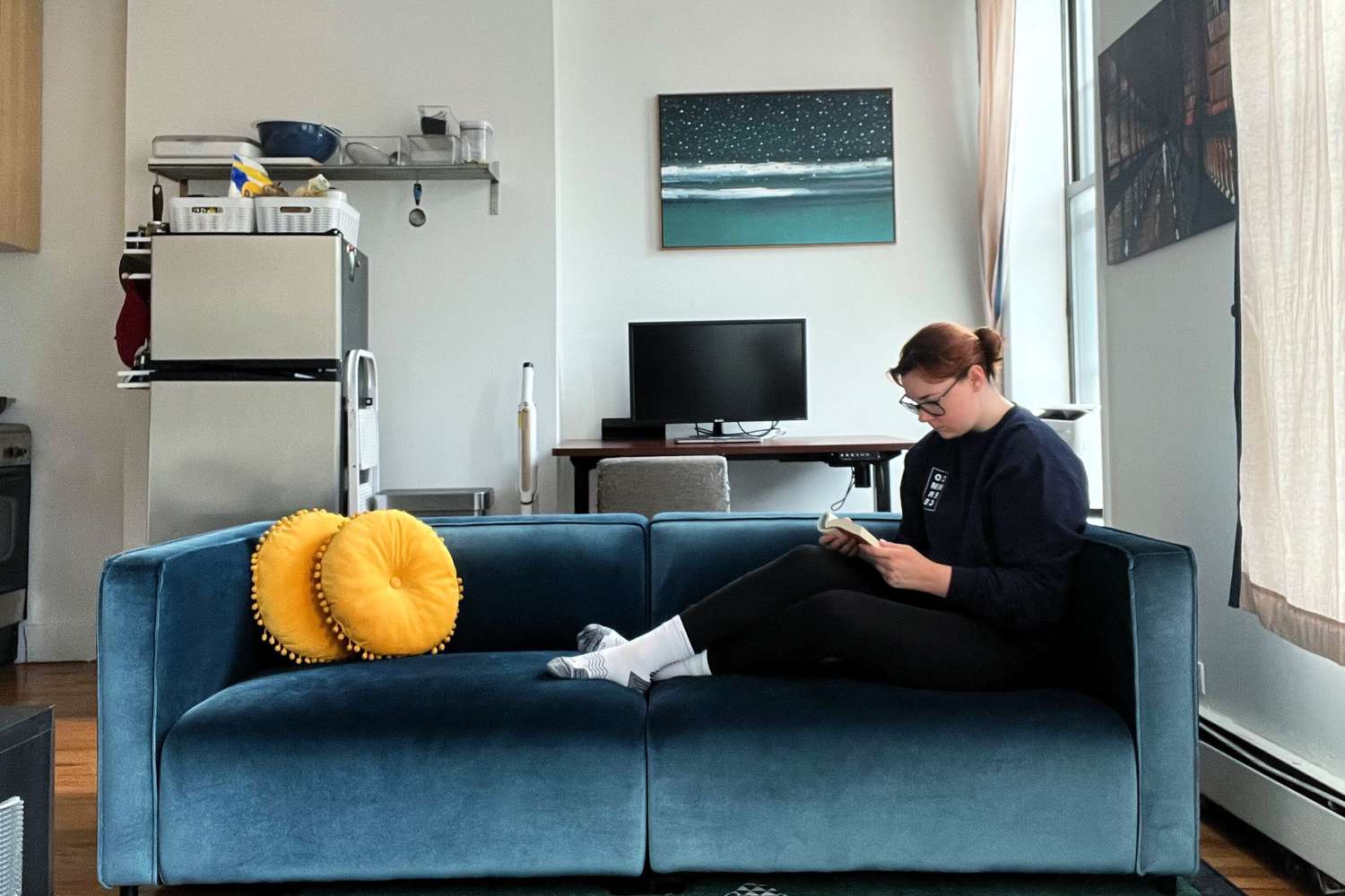 A dark blue velvet couch from Rove Concepts